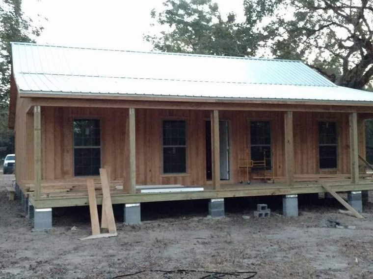 Cabin with metal roof and full front porch