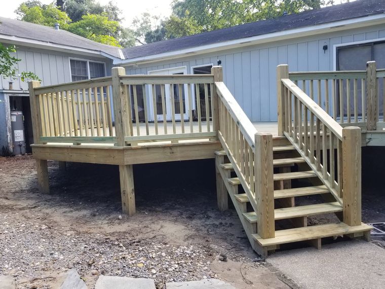 Pressure-treated deck with railings and stairs