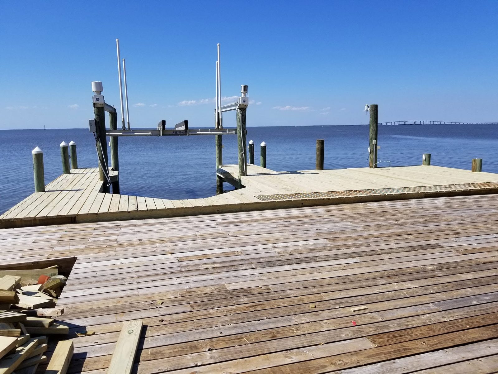 Wooden pier built out over Mobile Bay at sunrise