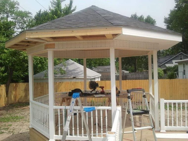 Backyard gazebo with white railings